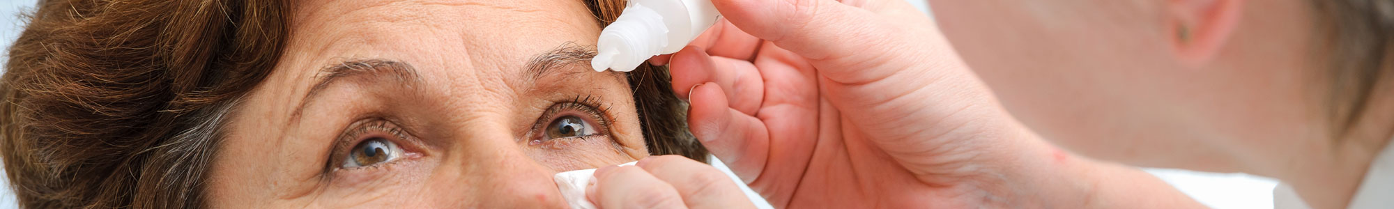 Woman being treated for dry eye with eye drops 